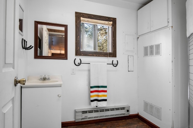 437 Tie Chute Ln, Florence, MT 59833 - bathroom featuring a baseboard radiator, baseboards, vanity, and wood finished floors