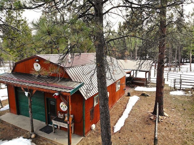 view of snowy exterior with metal roof