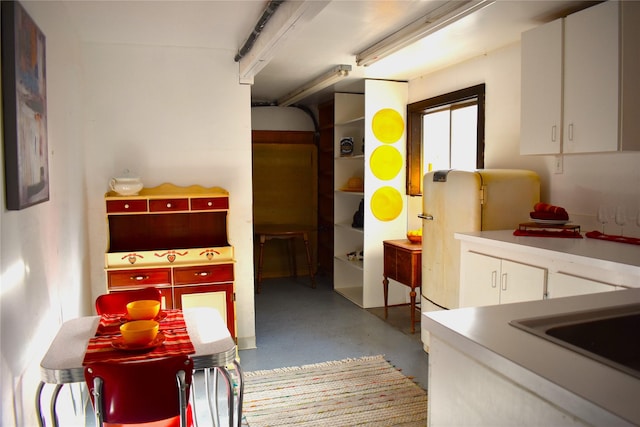 interior space featuring a garage and finished concrete floors