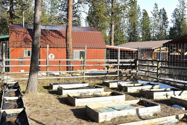 exterior space with a standing seam roof, metal roof, and an outdoor structure