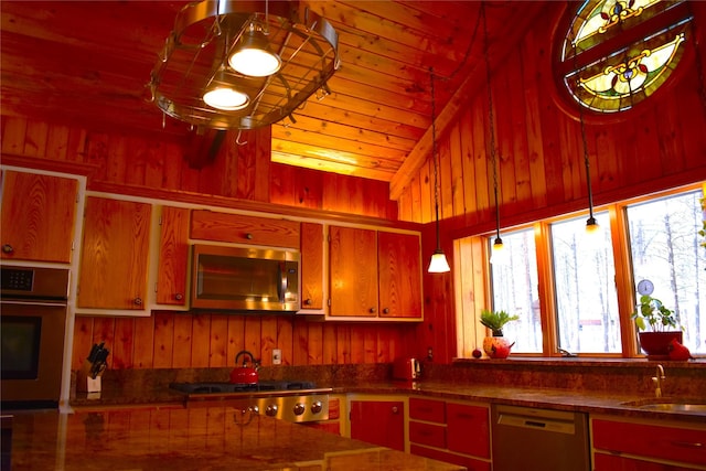 kitchen with wooden ceiling, wooden walls, stainless steel appliances, a sink, and pendant lighting