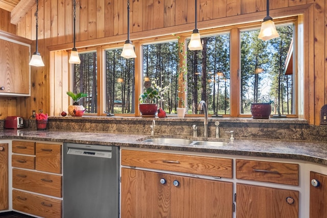437 Tie Chute Ln, Florence, MT 59833 - kitchen featuring dishwasher, a sink, brown cabinetry, decorative light fixtures, and wooden walls