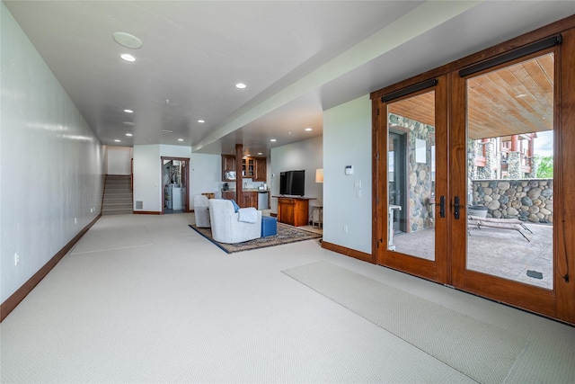 living room with recessed lighting, light carpet, baseboards, french doors, and stairway