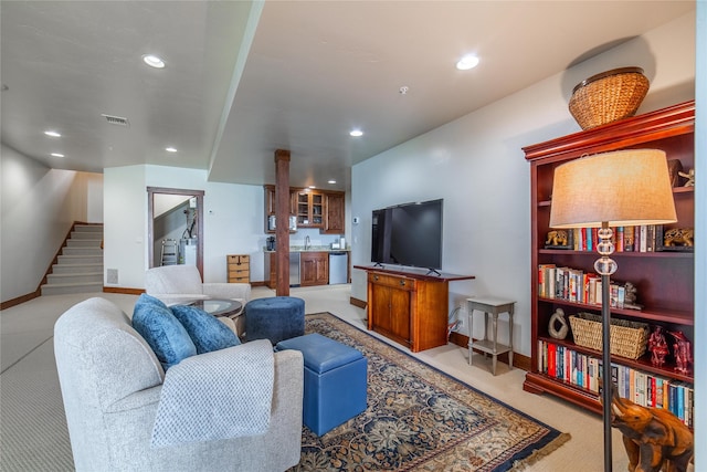 living room with recessed lighting, light carpet, visible vents, baseboards, and stairs