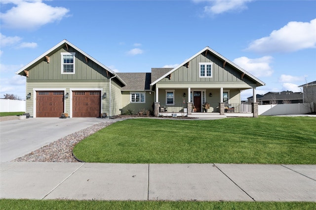 craftsman inspired home with a porch, concrete driveway, board and batten siding, a garage, and a front lawn