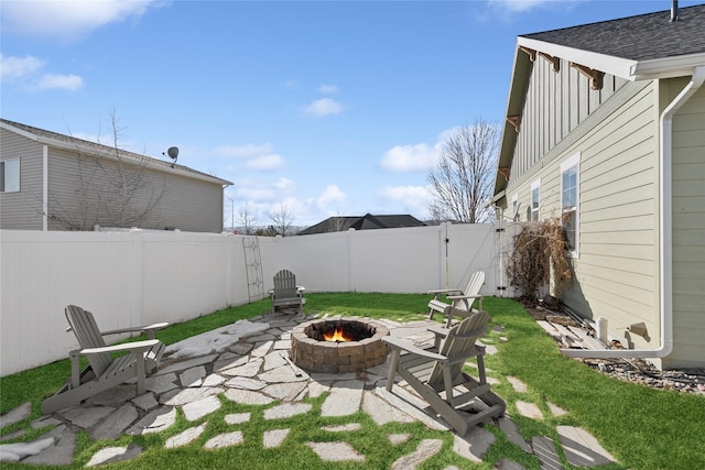 101 Shellan Way, Kalispell, MT 59901 - fenced backyard with a fire pit, a gate, and a patio area