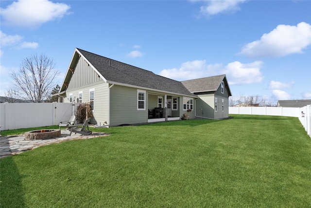 101 Shellan Way, Kalispell, MT 59901 - rear view of house with an outdoor fire pit, board and batten siding, a patio, a fenced backyard, and roof with shingles
