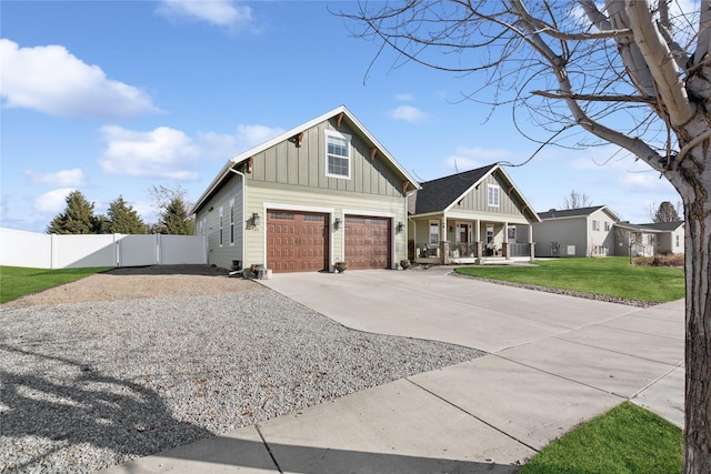 101 Shellan Way, Kalispell, MT 59901 - view of front of house with board and batten siding, driveway, covered porch, and an attached garage
