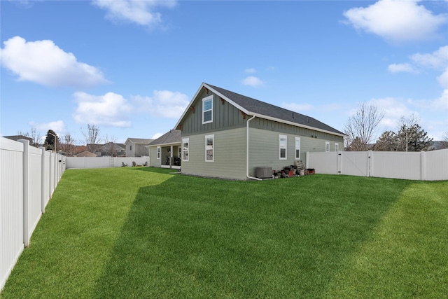 101 Shellan Way, Kalispell, MT 59901 - rear view of property with board and batten siding, a gate, and a fenced backyard