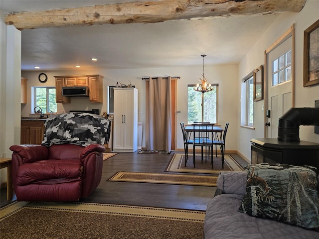 living area with baseboards, dark wood-style flooring, recessed lighting, and an inviting chandelier