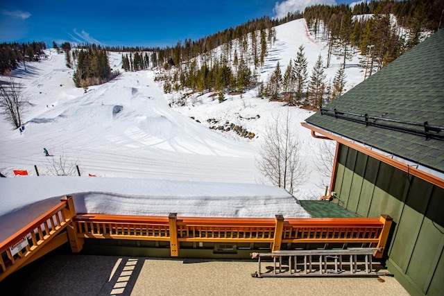 snow covered deck featuring a mountain view