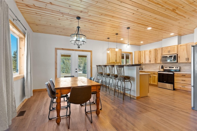 dining area with light wood finished floors, wood ceiling, visible vents, and french doors