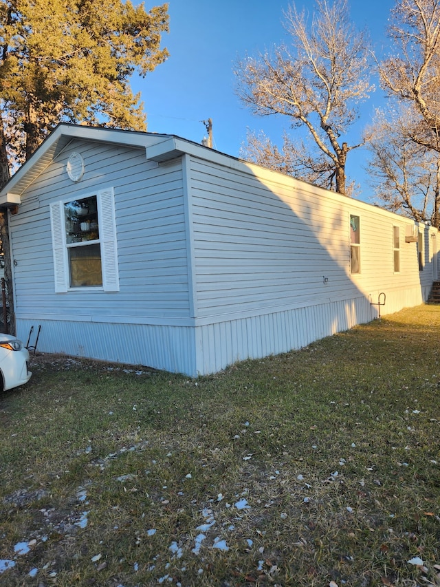 view of side of property with a lawn