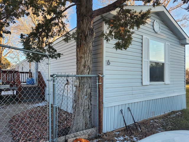 view of side of home featuring fence