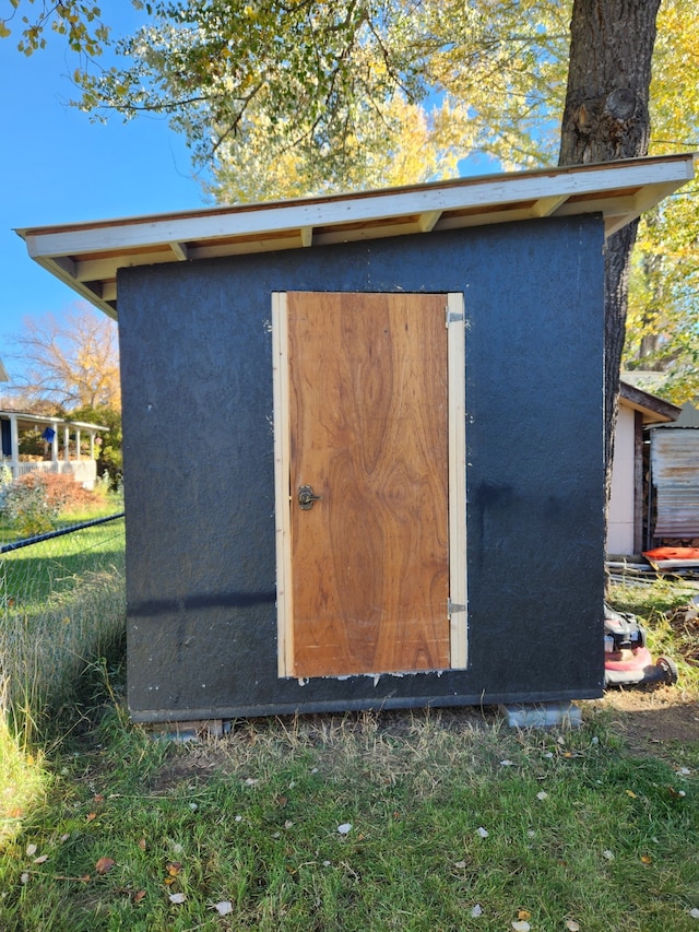 view of shed featuring fence