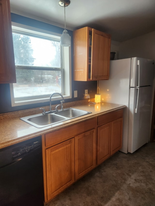 kitchen with black dishwasher, brown cabinetry, freestanding refrigerator, glass insert cabinets, and a sink