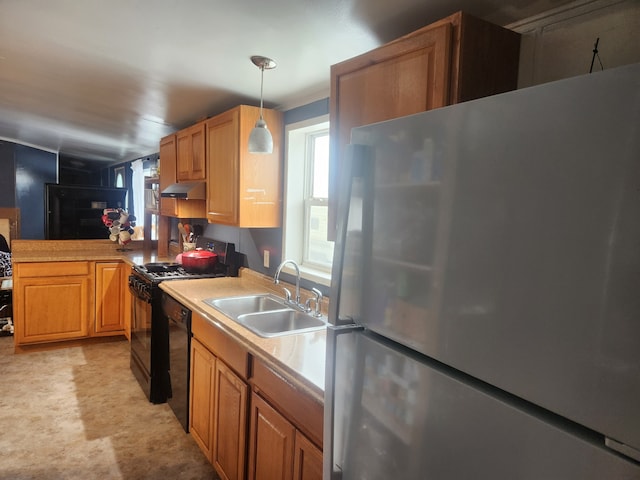 kitchen featuring decorative light fixtures, under cabinet range hood, light countertops, black appliances, and a sink