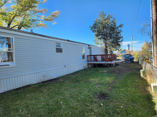 view of yard with fence and a wooden deck