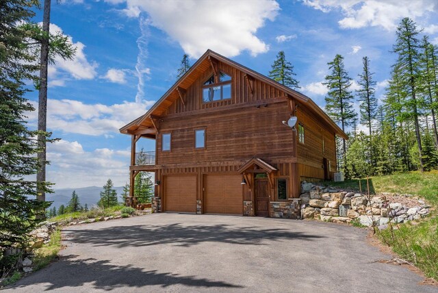 476 Elk Highlands Dr, Whitefish, MT 59937 - view of front facade featuring asphalt driveway, a garage, and a mountain view