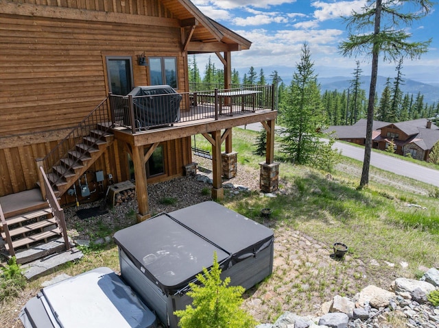476 Elk Highlands Dr, Whitefish, MT 59937 - view of yard with stairs, a deck with mountain view, and a hot tub