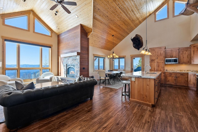 476 Elk Highlands Dr, Whitefish, MT 59937 - living room with high vaulted ceiling, ceiling fan, dark wood-style floors, a chandelier, and healthy amount of natural light