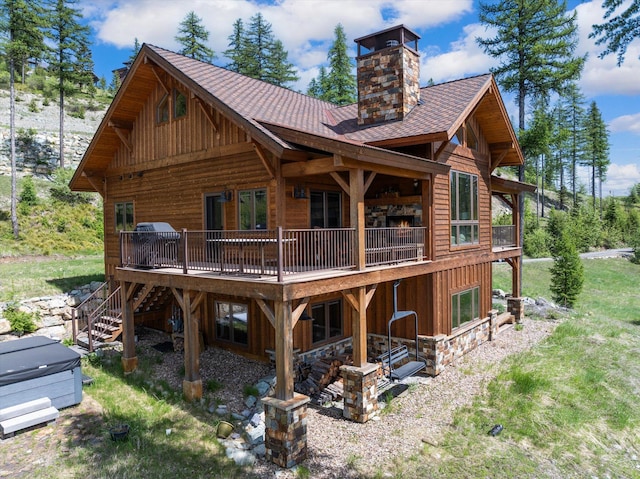 476 Elk Highlands Dr, Whitefish, MT 59937 - rear view of property featuring board and batten siding, roof with shingles, a deck, and a chimney