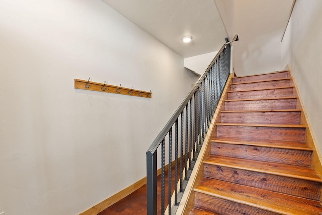 stairway featuring baseboards