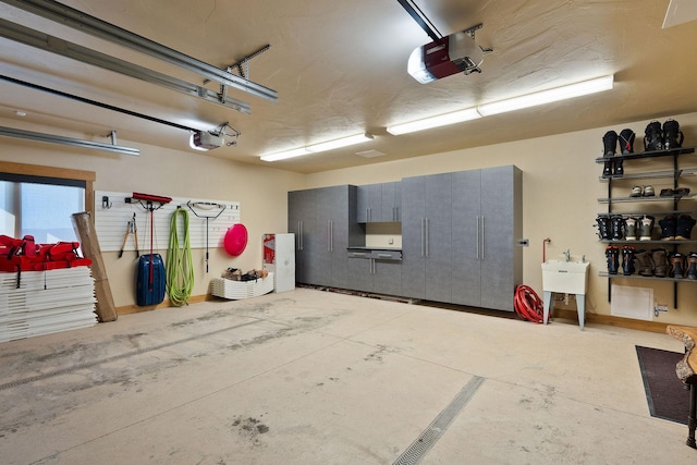 garage featuring a sink and a garage door opener