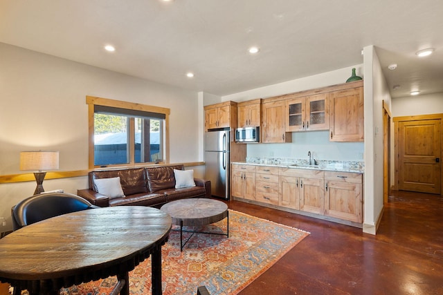 476 Elk Highlands Dr, Whitefish, MT 59937 - kitchen with stainless steel appliances, a sink, recessed lighting, light countertops, and finished concrete floors