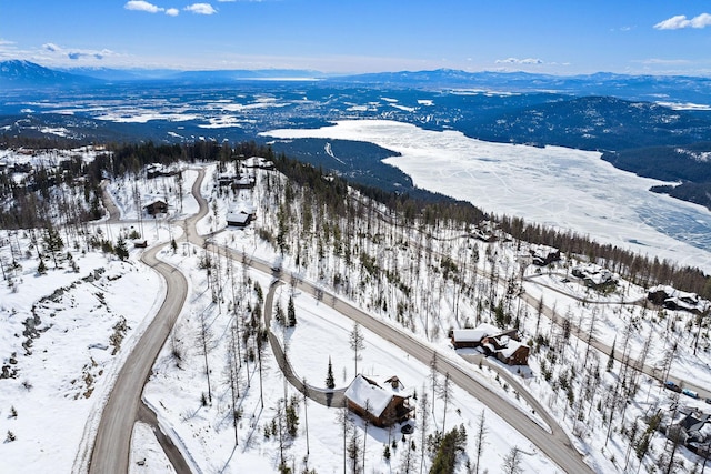 snowy aerial view with a mountain view