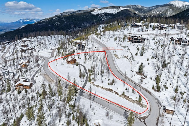 snowy aerial view with a mountain view