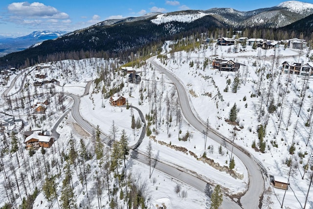 snowy aerial view with a mountain view