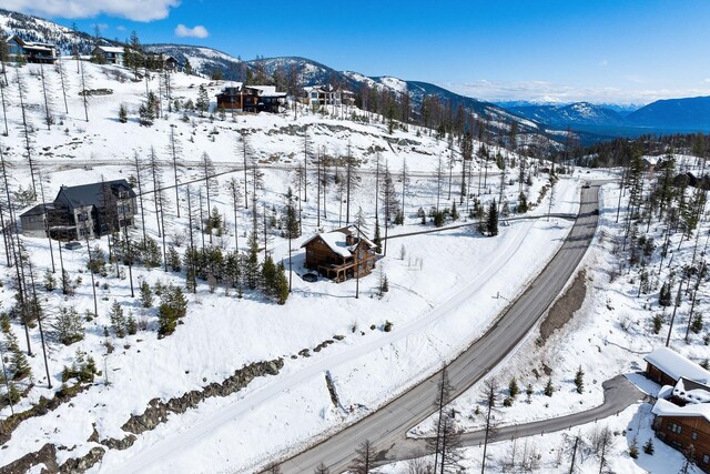 snowy aerial view with a mountain view