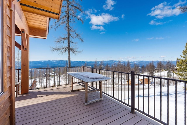 snow covered deck featuring a mountain view