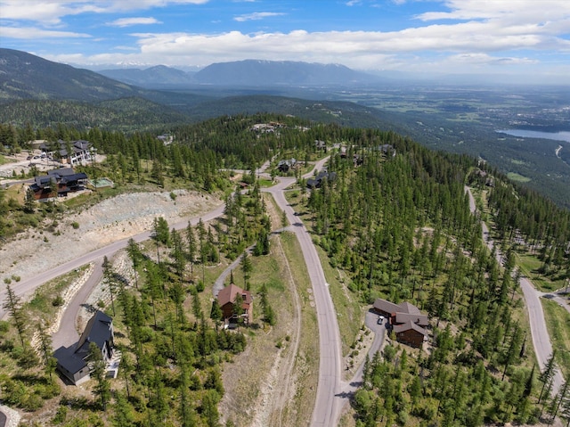 476 Elk Highlands Dr, Whitefish, MT 59937 - aerial view of property and surrounding area with a heavily wooded area and a mountain backdrop