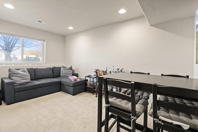 living room featuring carpet, visible vents, and recessed lighting