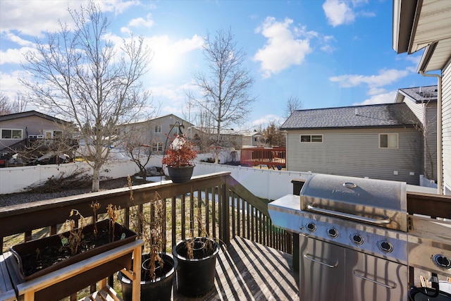 wooden terrace with fence and grilling area