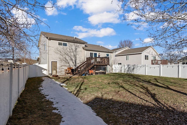 back of house featuring stairs, a yard, and a fenced backyard