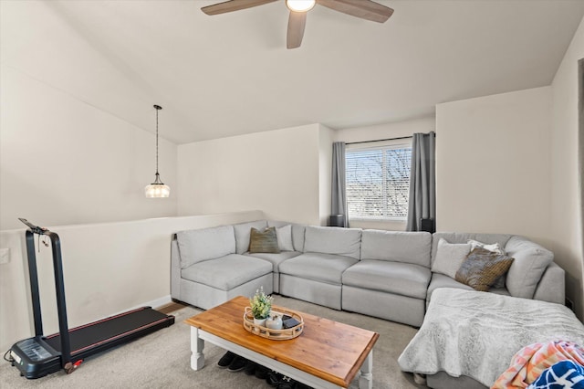 carpeted living area with a ceiling fan