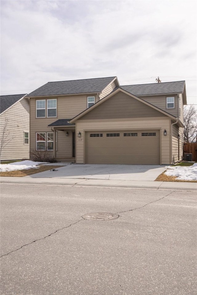 view of front facade with concrete driveway and an attached garage