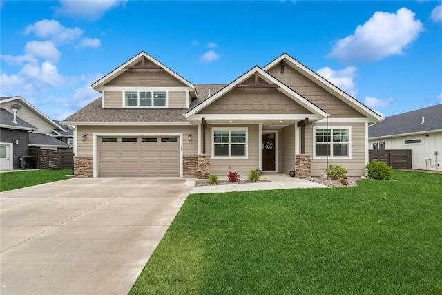 154 W Swift Creek Way, Kalispell, MT 59901 - craftsman-style house with concrete driveway, roof with shingles, stone siding, and an attached garage