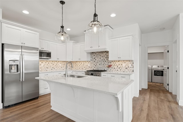 154 W Swift Creek Way, Kalispell, MT 59901 - kitchen featuring appliances with stainless steel finishes, washing machine and clothes dryer, white cabinets, tasteful backsplash, and recessed lighting