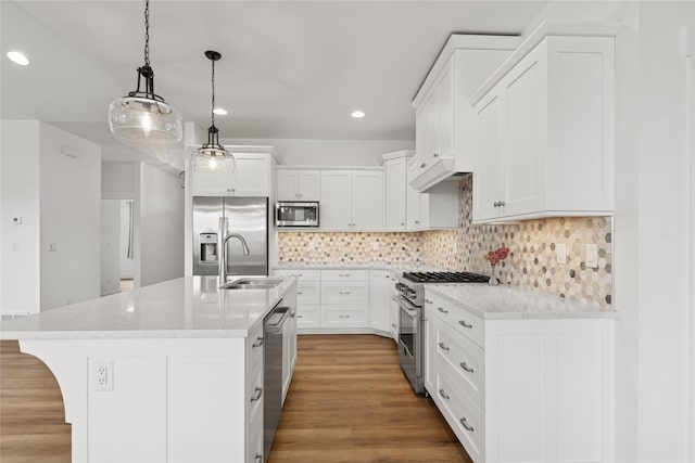 154 W Swift Creek Way, Kalispell, MT 59901 - kitchen with stainless steel appliances, recessed lighting, wood finished floors, decorative backsplash, and white cabinetry