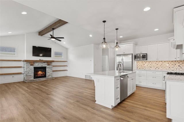 154 W Swift Creek Way, Kalispell, MT 59901 - kitchen featuring stainless steel appliances, ceiling fan, open floor plan, light countertops, and recessed lighting