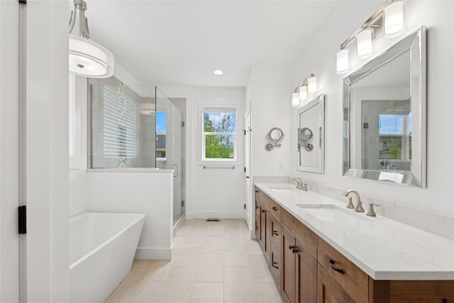 154 W Swift Creek Way, Kalispell, MT 59901 - bathroom with a freestanding bath, a shower stall, double vanity, tile patterned floors, and recessed lighting
