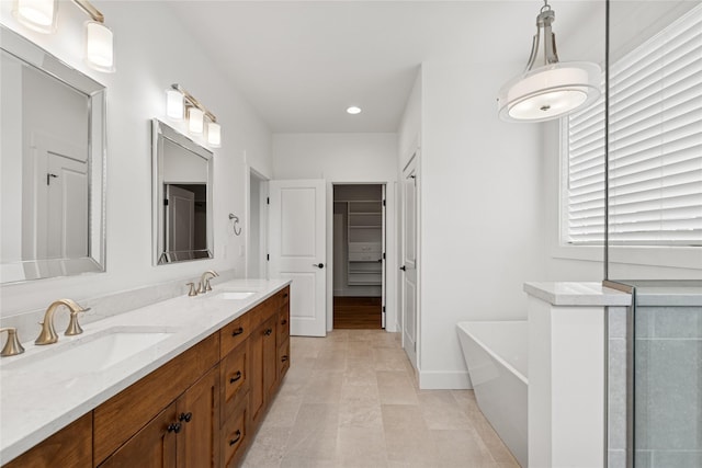 154 W Swift Creek Way, Kalispell, MT 59901 - bathroom featuring a freestanding bath, double vanity, recessed lighting, and a spacious closet
