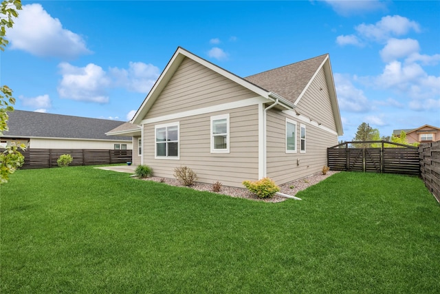 154 W Swift Creek Way, Kalispell, MT 59901 - rear view of house featuring a fenced backyard and a shingled roof