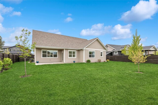 154 W Swift Creek Way, Kalispell, MT 59901 - back of property featuring a fenced backyard, a patio, and roof with shingles