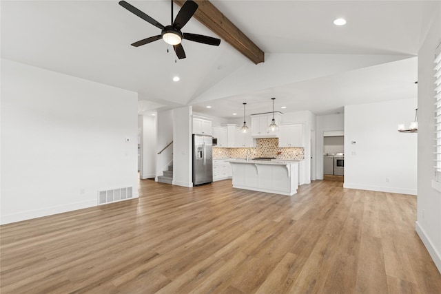 154 W Swift Creek Way, Kalispell, MT 59901 - unfurnished living room with washer and dryer, recessed lighting, ceiling fan, light wood-type flooring, and stairs