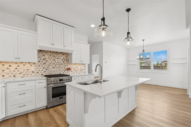 154 W Swift Creek Way, Kalispell, MT 59901 - kitchen featuring high end range, light wood-style flooring, backsplash, and white cabinetry
